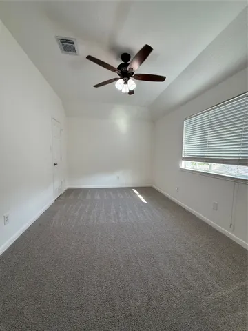 an empty room with a empty space and a ceiling fan