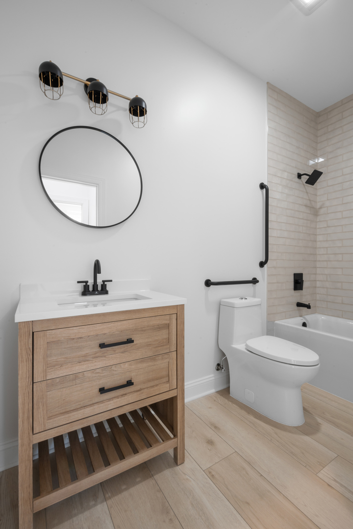 70 East Pershing Road, Unit 4W Chicago, IL 60653 - Photo 8 of 9 a bathroom with a toilet a sink and mirror