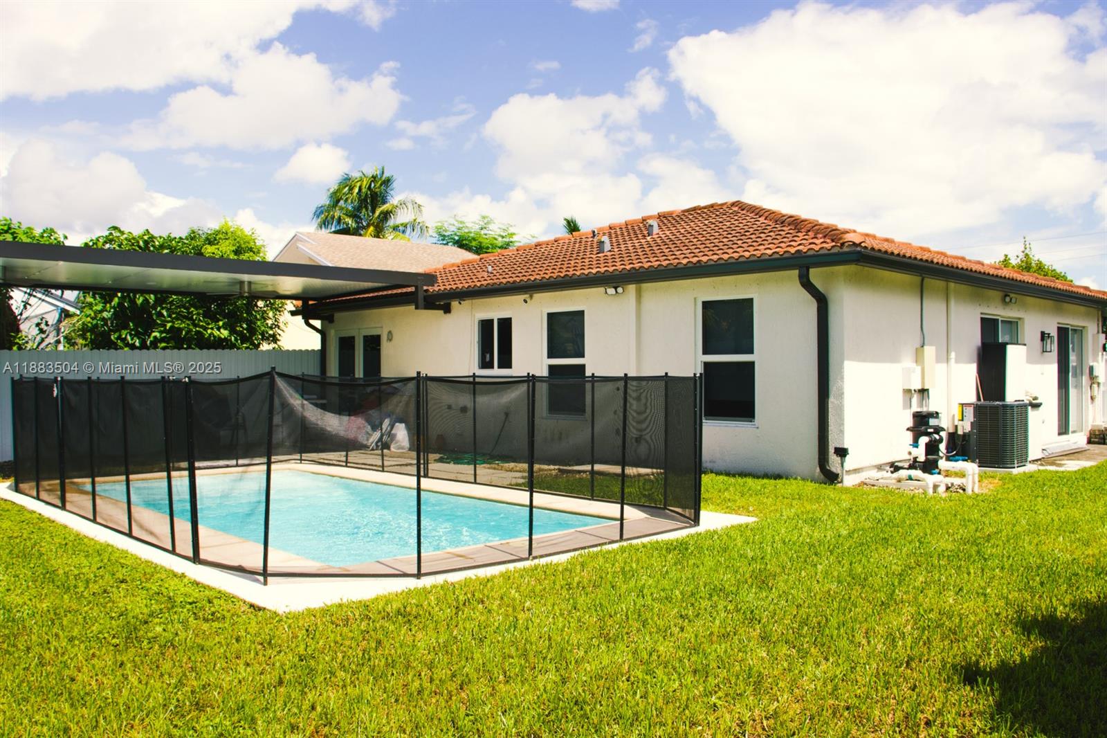 25760 Southwest 127th Court Homestead, FL 33032 - Photo 18 of 25 a backyard of a house with table and chairs