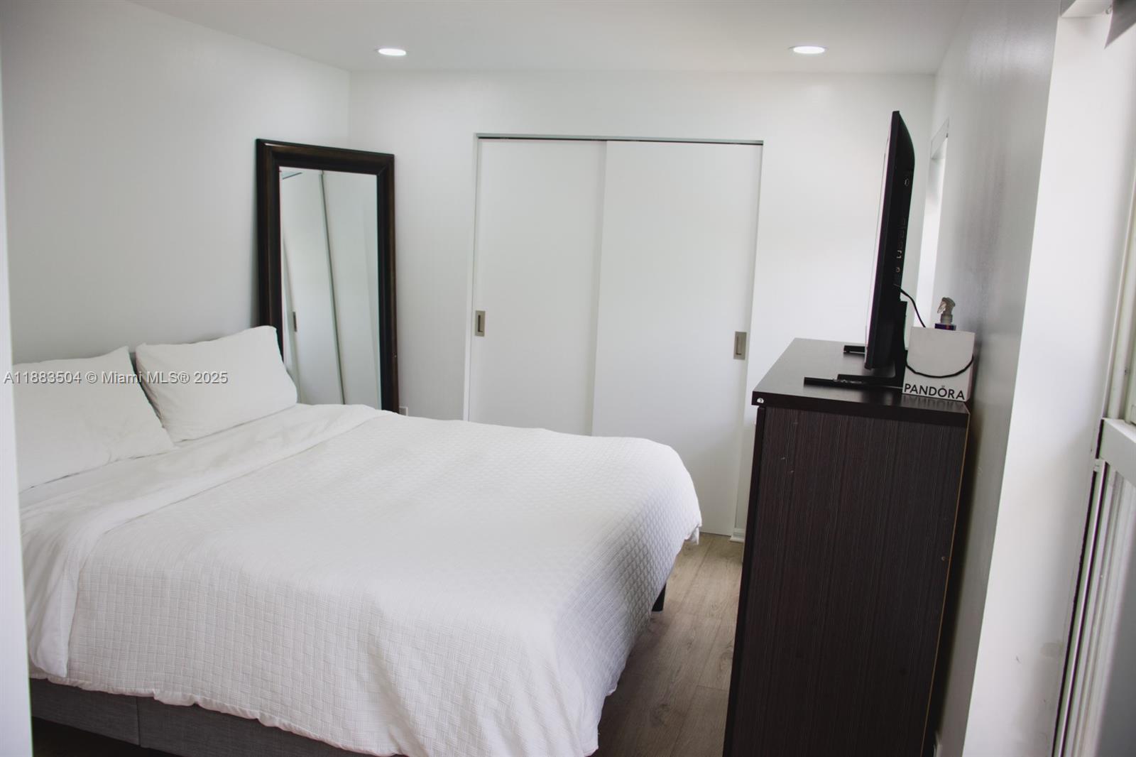 25760 Southwest 127th Court Homestead, FL 33032 - Photo 20 of 25 a bedroom with a bed and a flat screen tv