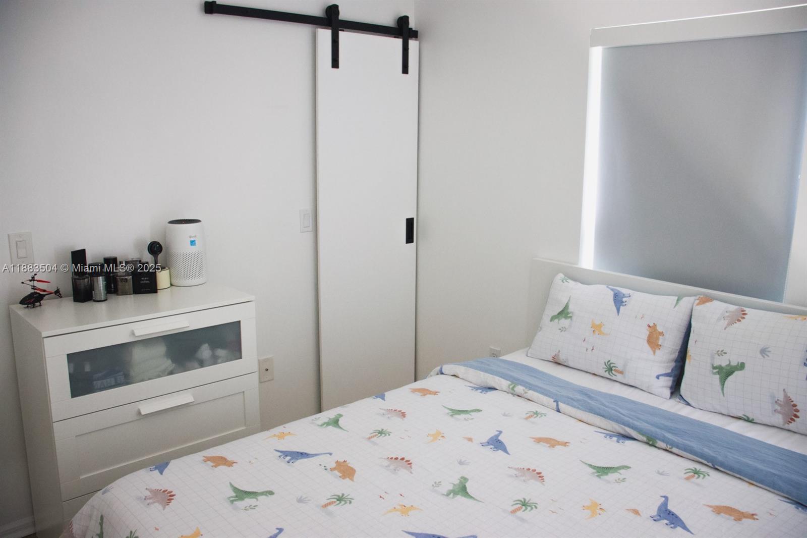 25760 Southwest 127th Court Homestead, FL 33032 - Photo 2 of 25 a bedroom with a bed and a fireplace