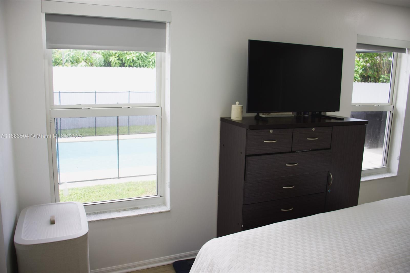 25760 Southwest 127th Court Homestead, FL 33032 - Photo 22 of 25 a bedroom with a bed and a flat screen tv