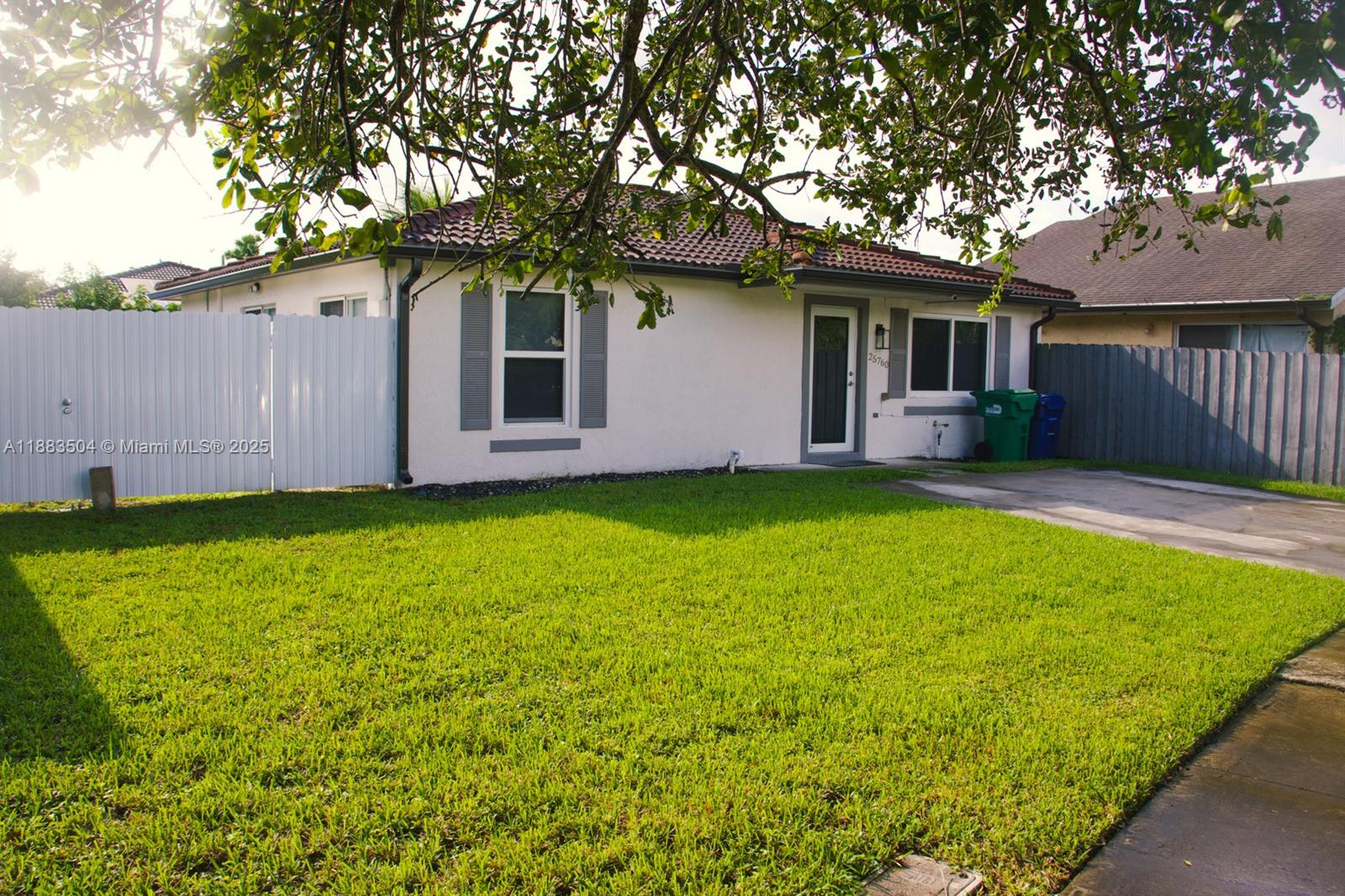 25760 Southwest 127th Court Homestead, FL 33032 - Photo 24 of 25 a front view of a house with a garden and yard