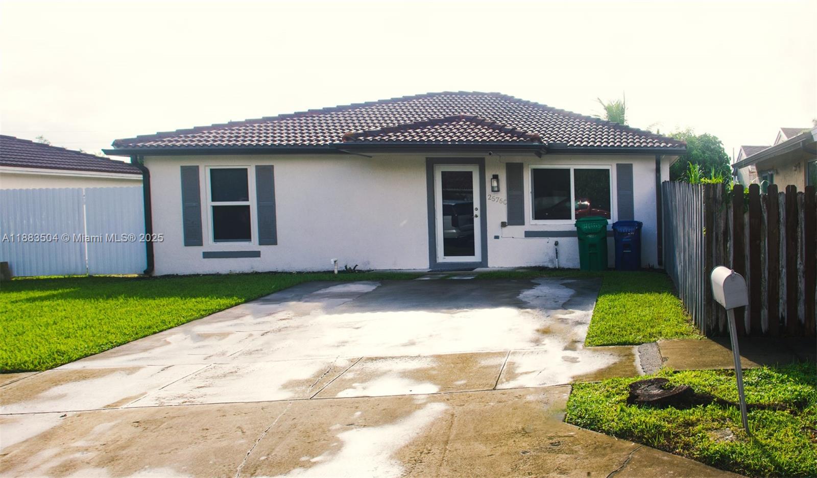 25760 Southwest 127th Court Homestead, FL 33032 - Photo 25 of 25 a front view of a house with a yard and garage