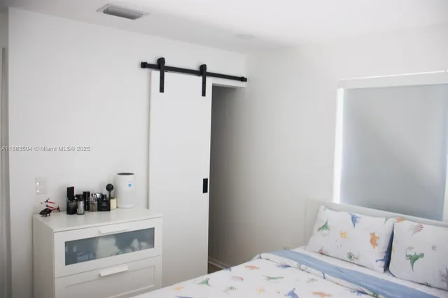 a bedroom with a bed and cabinets