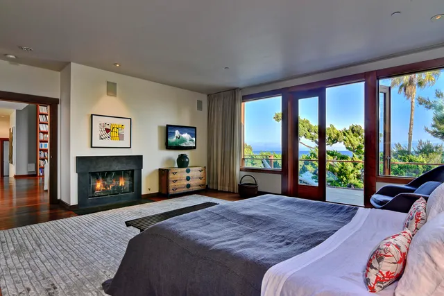 a bedroom with a bed and a fireplace