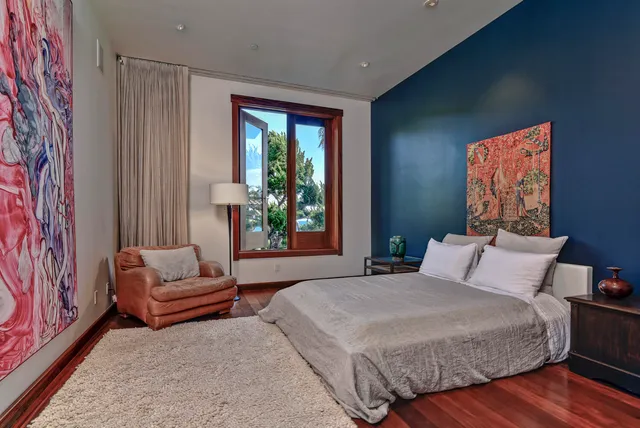 a bedroom with a bed and a couch