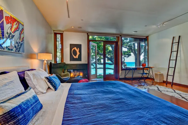 a living room with furniture a rug and a large window