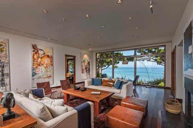 a living room with furniture and a floor to ceiling window