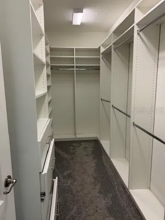 a view of an empty walk in closet