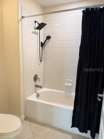 a bathroom with a bathtub and shower
