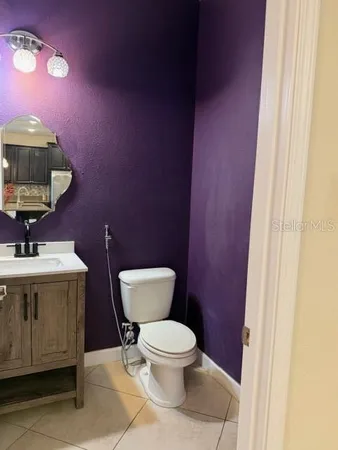 a bathroom with a toilet a sink and mirror