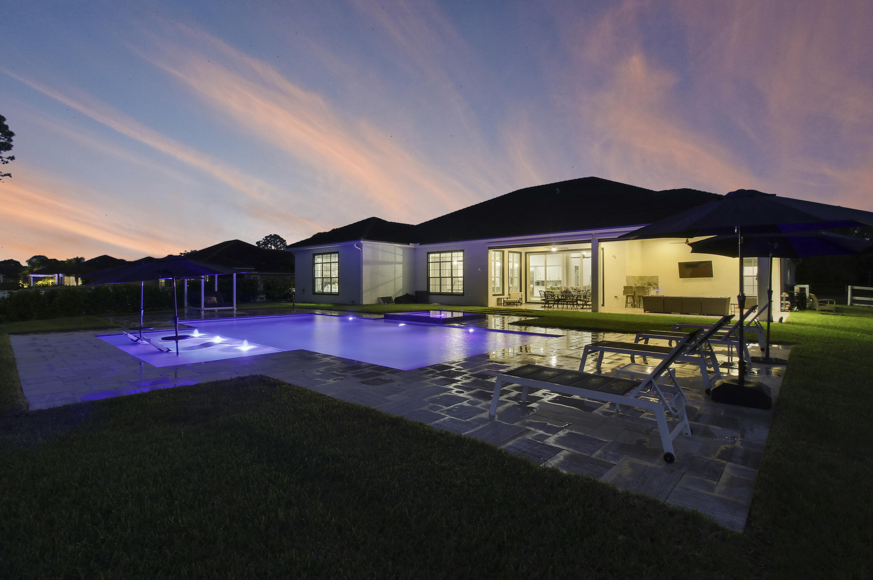16127 Cadence Pass Jupiter, FL 33478 - Photo 52 of 65 a view of a big yard with table & chairs under an umbrella
