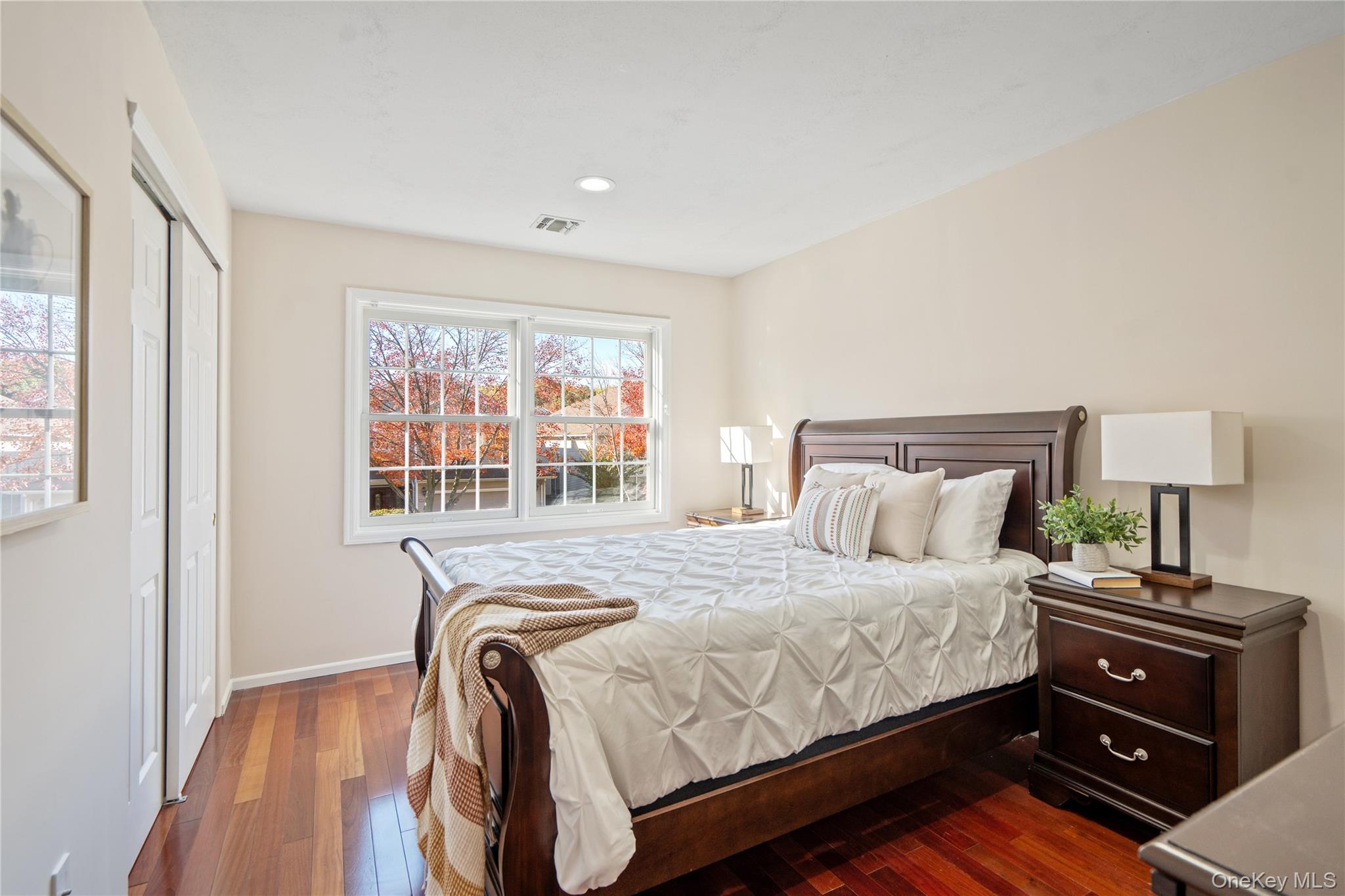 176 Sagamore Drive Plainview, NY 11803 - Photo 20 of 40 a bedroom with a bed and wooden floor