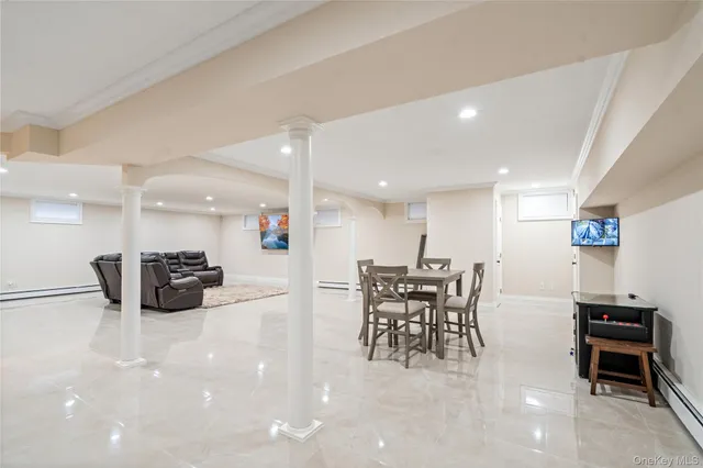 a living room with furniture and a large window with wooden floor