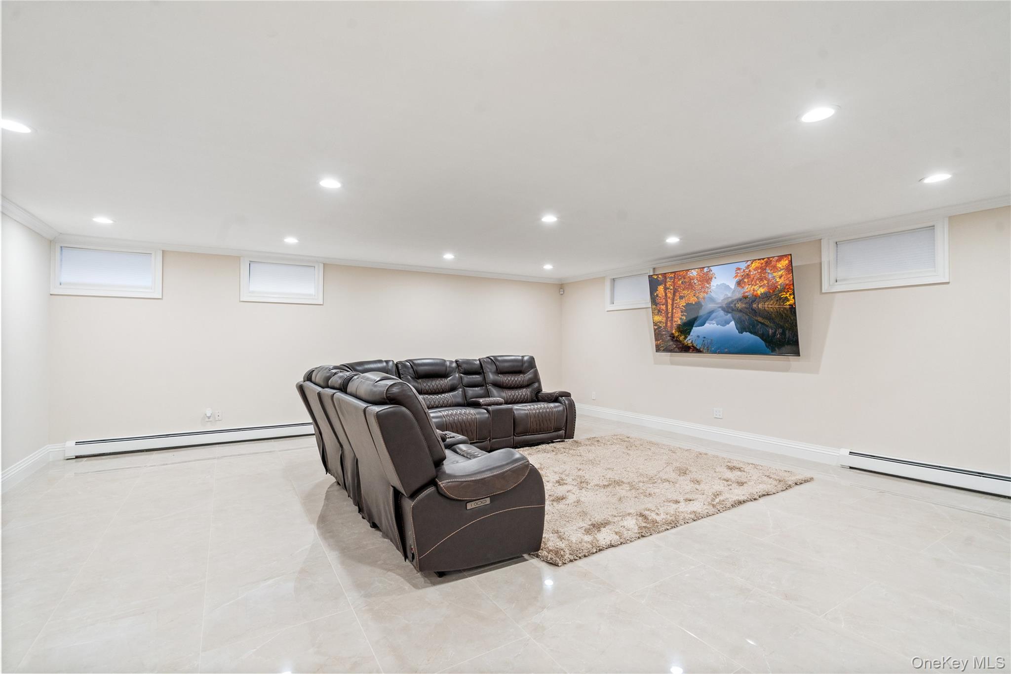 176 Sagamore Drive Plainview, NY 11803 - Photo 23 of 40 a living room with couches and a flat screen tv