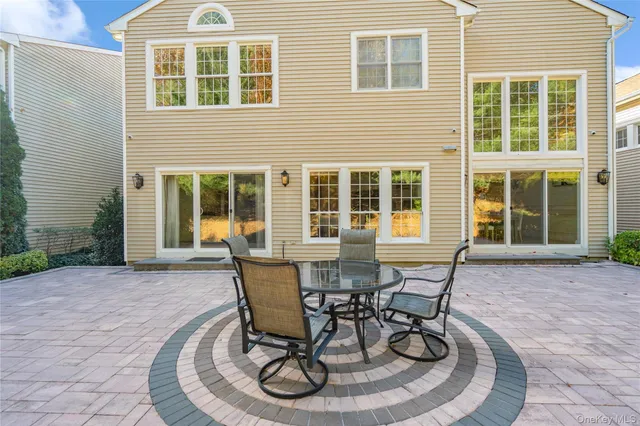 a view of a house with backyard and sitting area