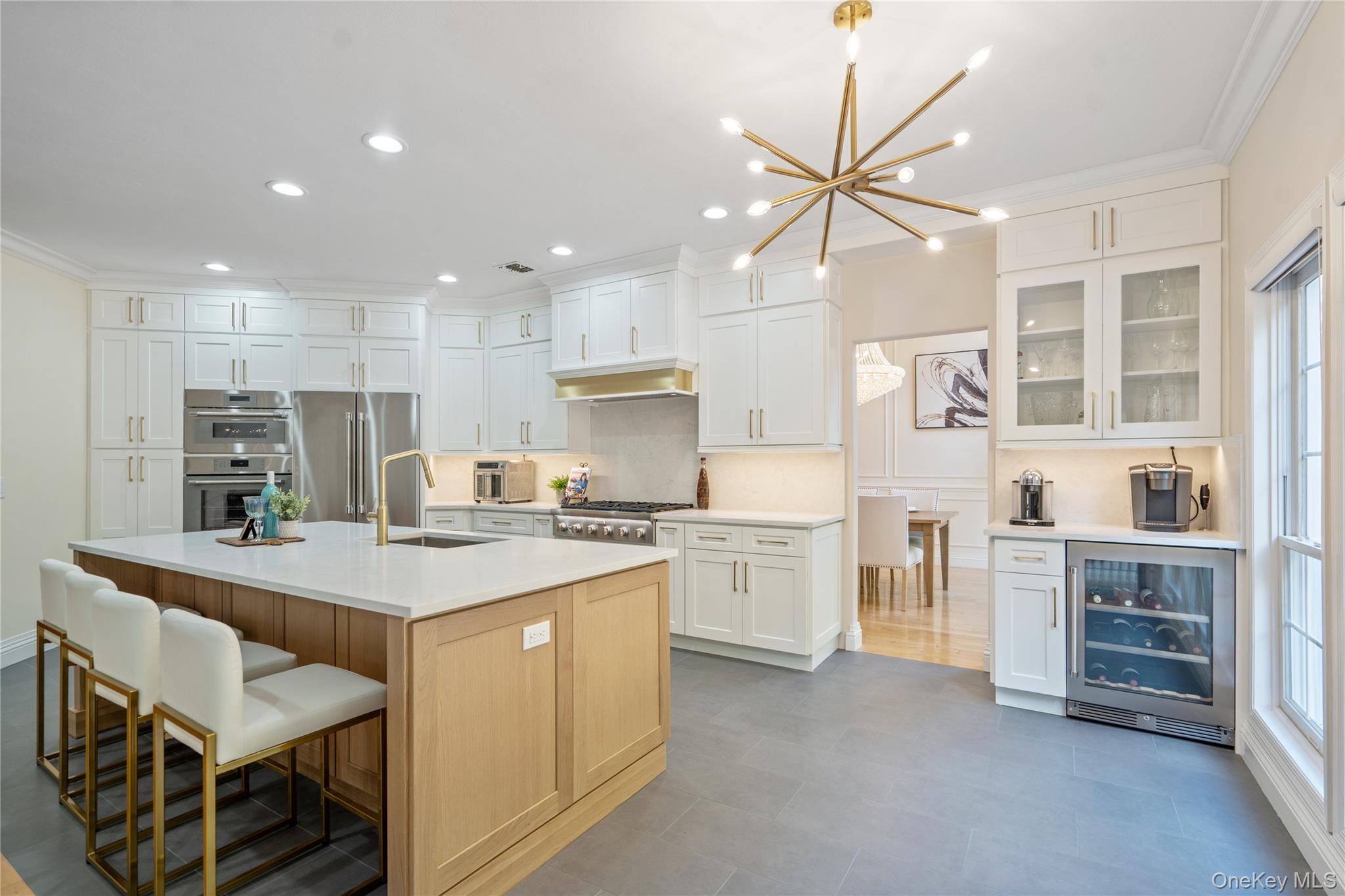 176 Sagamore Drive Plainview, NY 11803 - Photo 8 of 40 a large kitchen with kitchen island a stove a table and chairs
