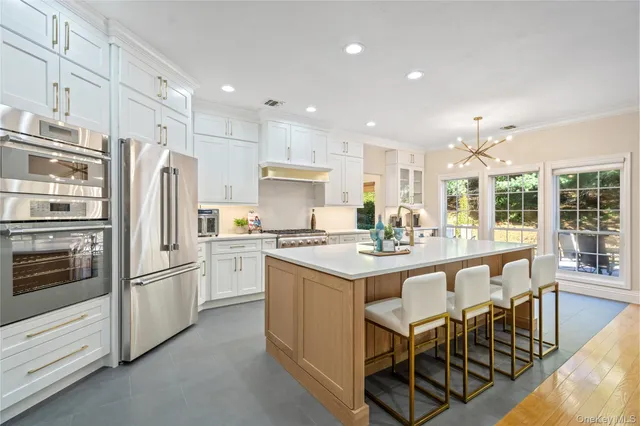 a kitchen with stainless steel appliances granite countertop a stove refrigerator sink and cabinets