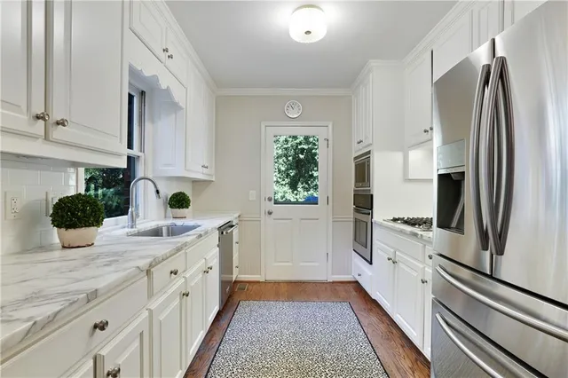 a kitchen with a refrigerator and a sink
