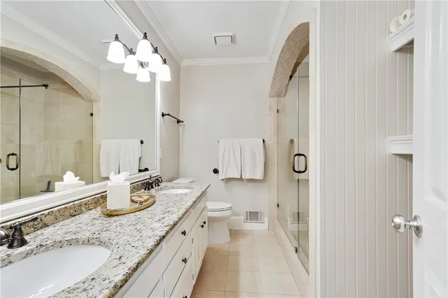 a spacious bathroom with a granite countertop sink a mirror and a shower