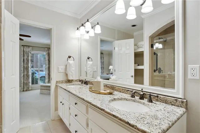 a bathroom with double vanity sinks a vanity a lamp and a mirror