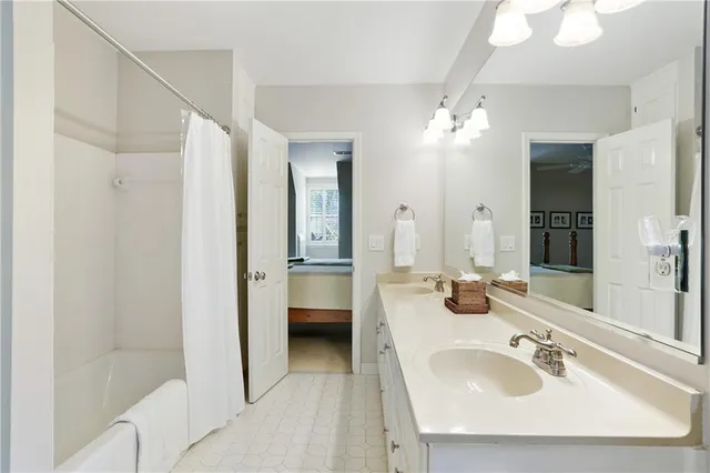 a en suite bathroom with a double vanity sink a mirror and a shower