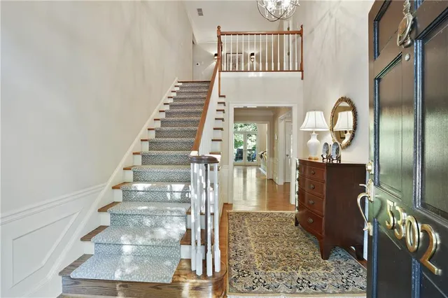 a view of entryway and hall with wooden floor