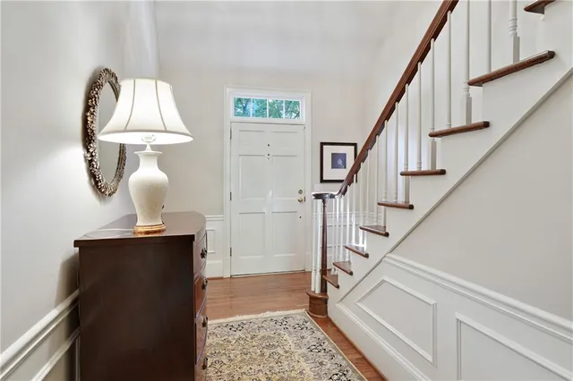 a view of entryway and bedroom with wooden floor