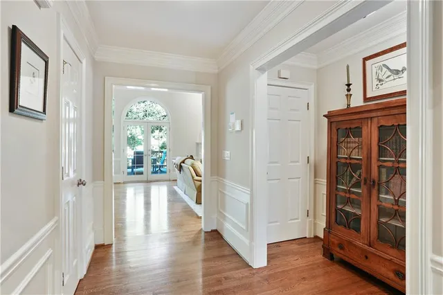 a view of a hallway with wooden floor and windows