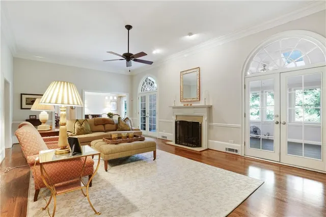 a living room with furniture a fireplace and a chandelier