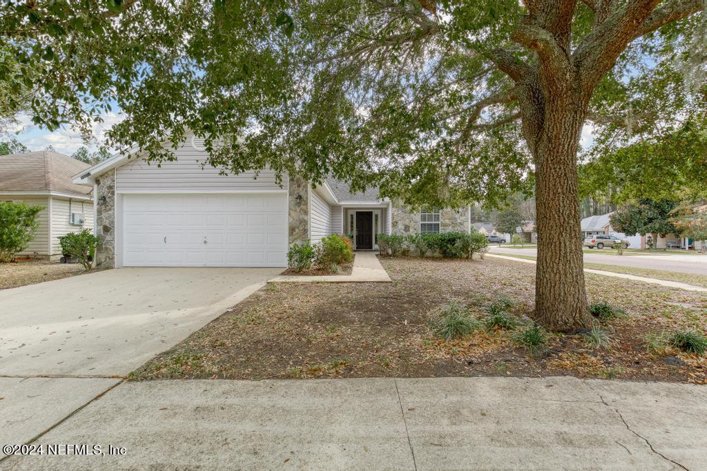 96014 Morton Lane Yulee, FL 32097 - Photo 1 of 45 a view of a house with a yard and large tree