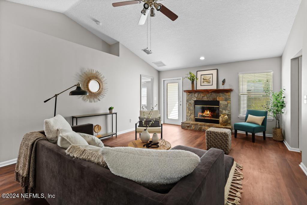 96014 Morton Lane Yulee, FL 32097 - Photo 11 of 45 a living room with furniture a fireplace and a flat screen tv