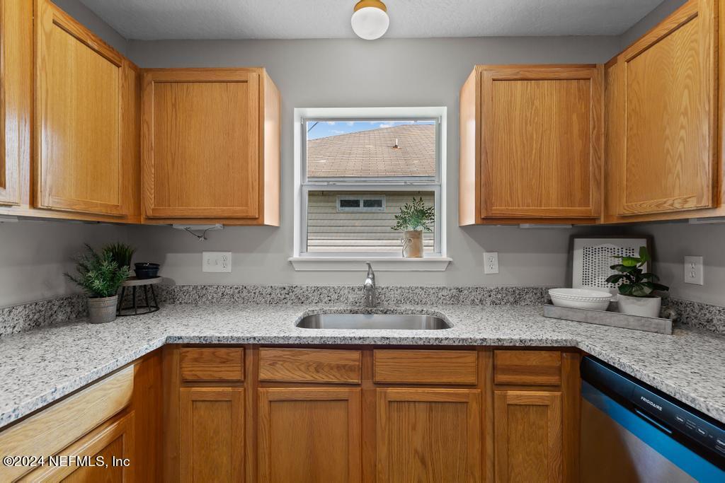 96014 Morton Lane Yulee, FL 32097 - Photo 19 of 45 a kitchen with granite countertop cabinets sink and window
