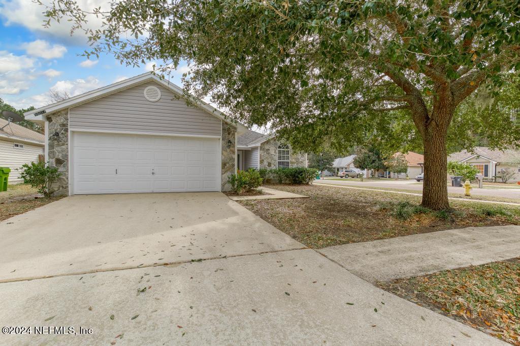 96014 Morton Lane Yulee, FL 32097 - Photo 2 of 45 a view of garage yard and tree