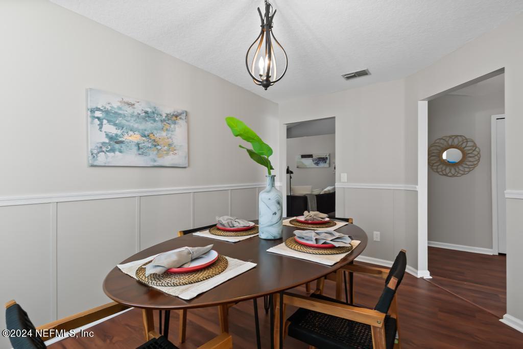 96014 Morton Lane Yulee, FL 32097 - Photo 22 of 45 a view of a dining room with furniture and wooden floor