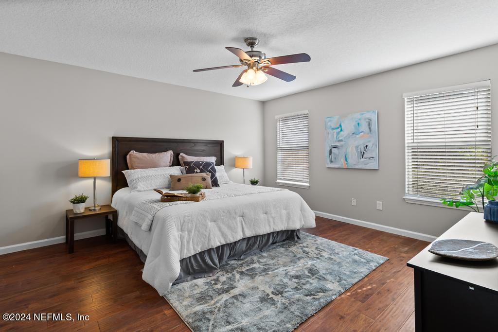 96014 Morton Lane Yulee, FL 32097 - Photo 24 of 45 a bed room with a bed and a chandelier
