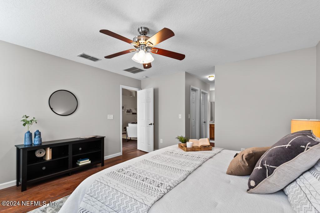 96014 Morton Lane Yulee, FL 32097 - Photo 26 of 45 a bedroom with a bed and a chandelier