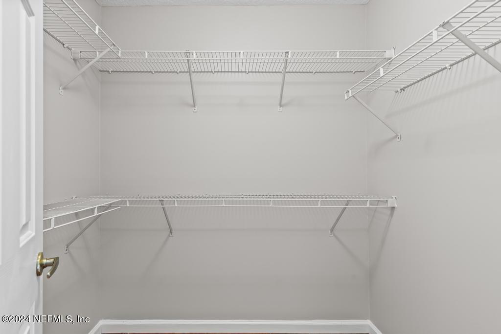 96014 Morton Lane Yulee, FL 32097 - Photo 28 of 45 a view of a room with racks on the wall