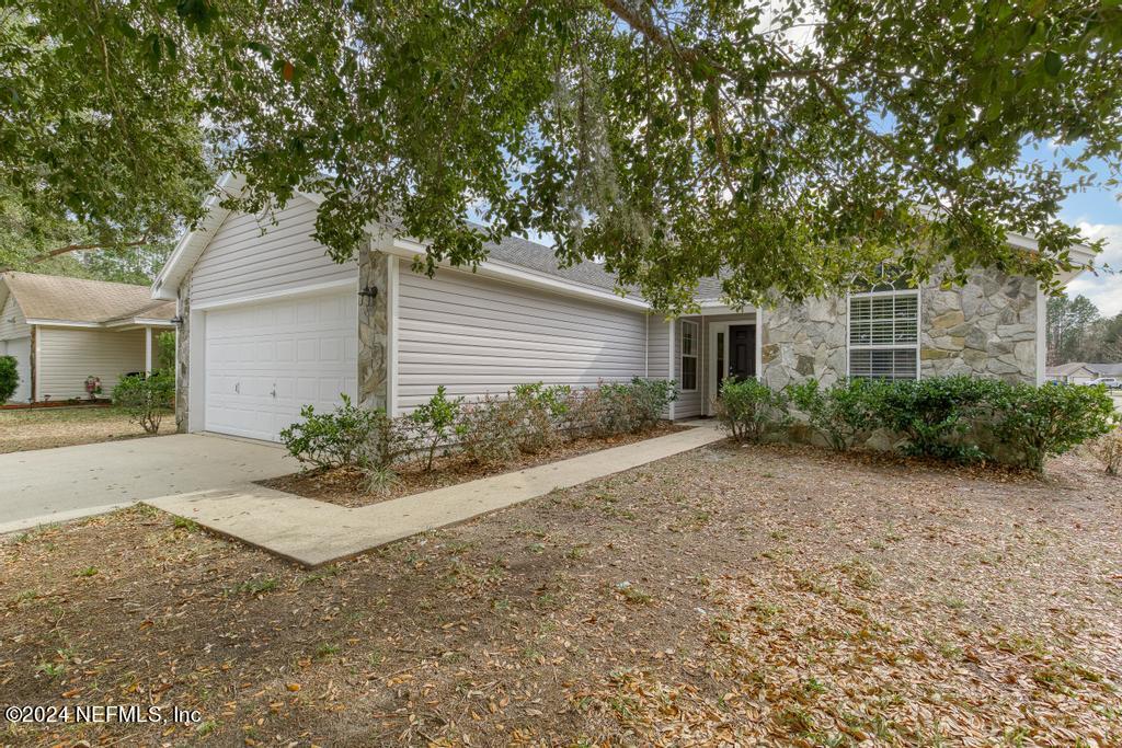 96014 Morton Lane Yulee, FL 32097 - Photo 3 of 45 a view of a house with yard and plants