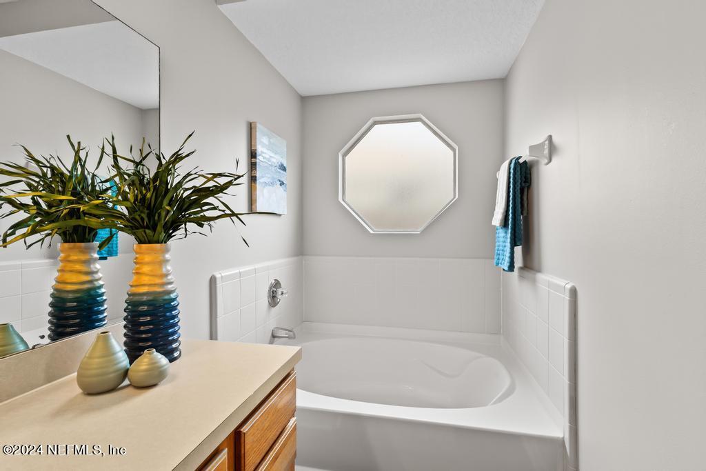 96014 Morton Lane Yulee, FL 32097 - Photo 31 of 45 a bathroom with a tub sink and mirror