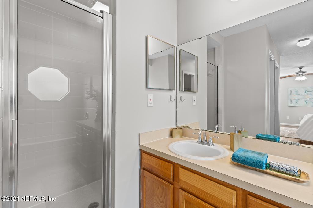 96014 Morton Lane Yulee, FL 32097 - Photo 33 of 45 a bathroom with a granite countertop sink and a mirror
