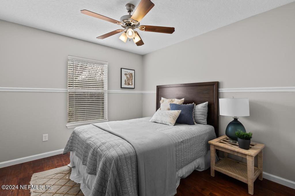 96014 Morton Lane Yulee, FL 32097 - Photo 34 of 45 a bedroom with a bed and a chandelier