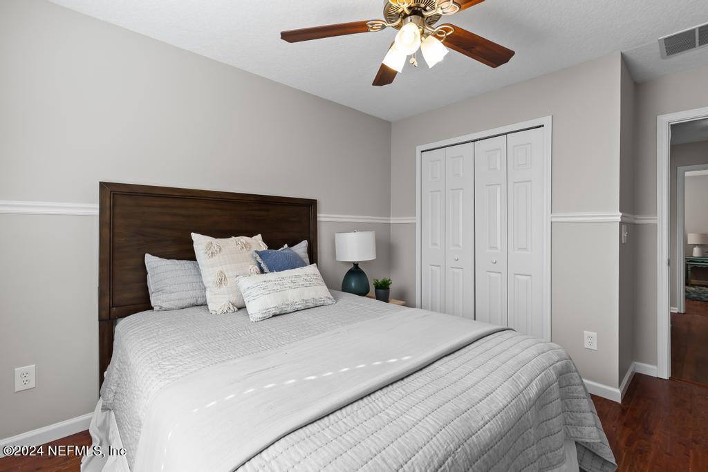 96014 Morton Lane Yulee, FL 32097 - Photo 35 of 45 a bedroom with a large bed and a chandelier