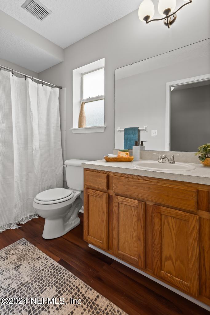 96014 Morton Lane Yulee, FL 32097 - Photo 37 of 45 a spacious bathroom with a double vanity sink toilet and a mirror