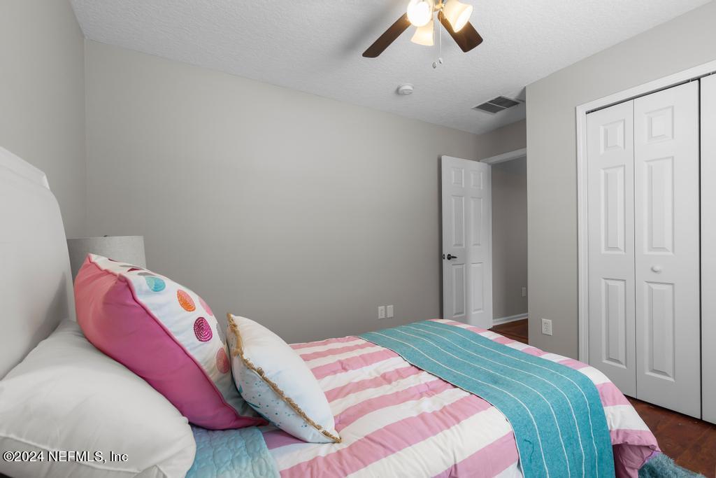 96014 Morton Lane Yulee, FL 32097 - Photo 39 of 45 a bedroom with a bed and a painting on the wall