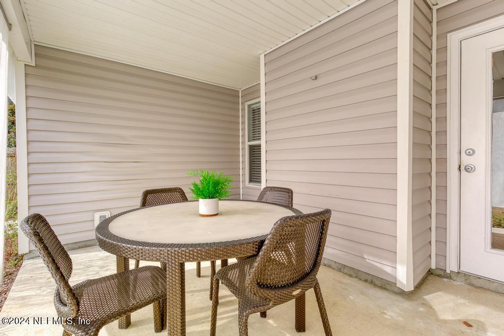 96014 Morton Lane Yulee, FL 32097 - Photo 40 of 45 a view of outdoor dining space with a table and chairs