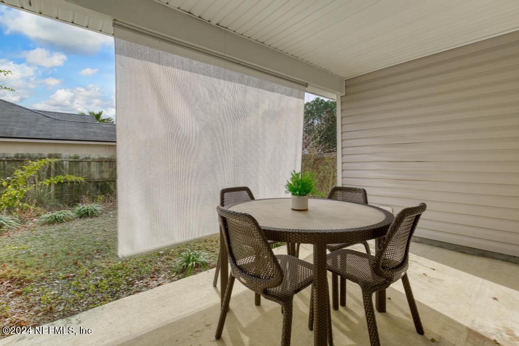 96014 Morton Lane Yulee, FL 32097 - Photo 41 of 45 a view of a patio with table and chairs and potted plants