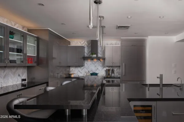 a kitchen with a table chairs stove and refrigerator