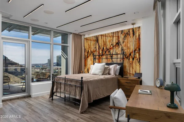 a bedroom with a bed and a large window